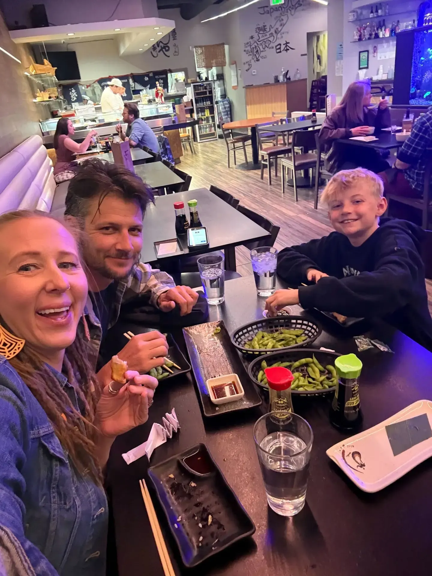 Jake's family taking a selfie at a restaurant table