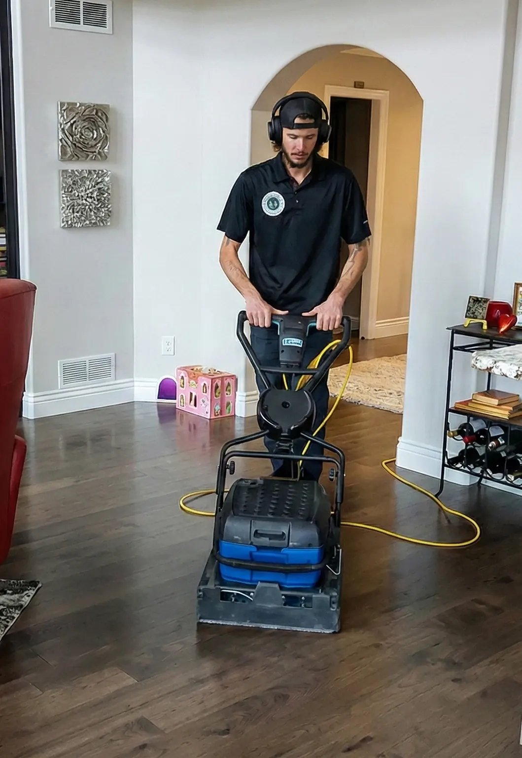 Jake in a customer's hallway with his carpet cleaning machine