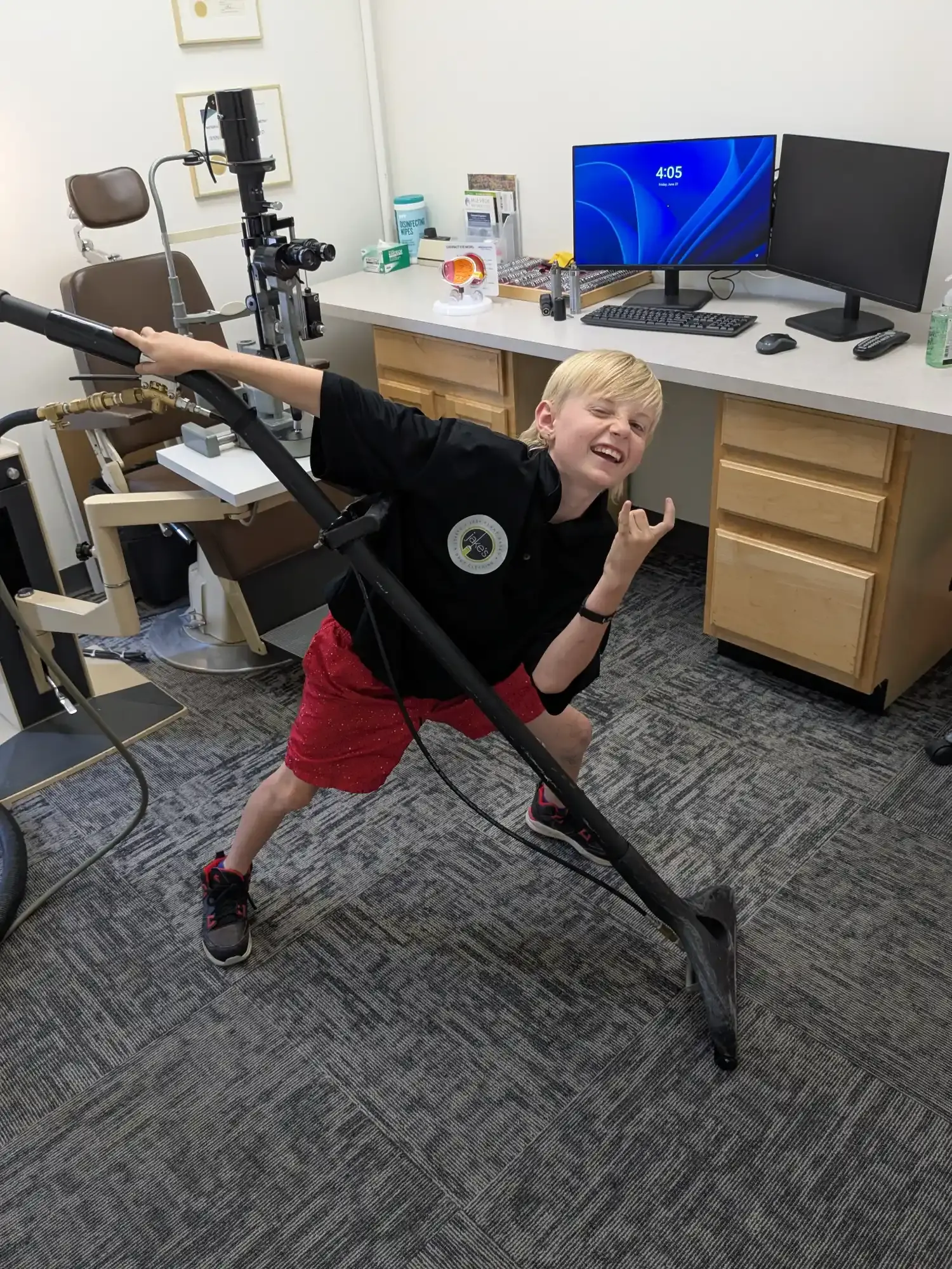 Jake's son vacuuming a home office carpet with a professional wand